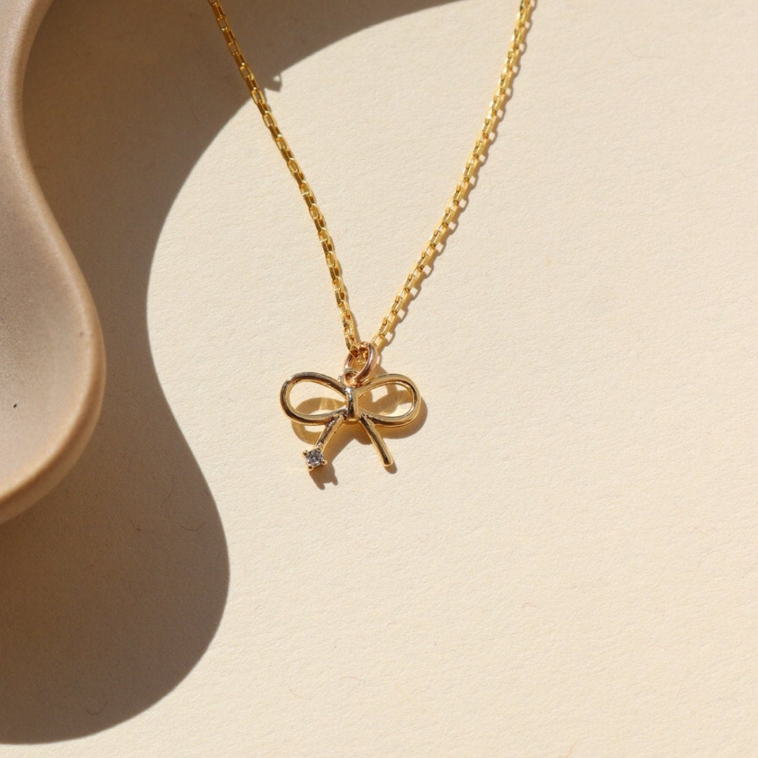 TKN Petite Bow Charm Necklace